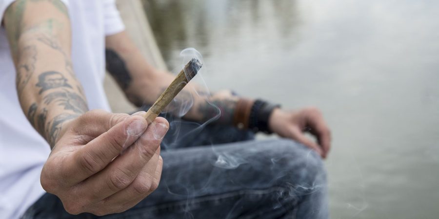 Man holding a marijuana joint