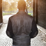 man looking at light at end of tunnel