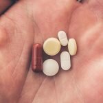 Man holds prescription drugs he's addicted to in his hand