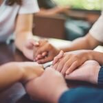 Support group for overdose holing hands on international overdose awareness day
