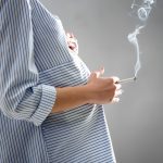 Woman smoking while pregnant and in need of detoxing from drugs